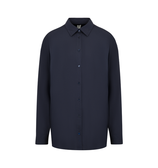Image 1 of 2 - NAVY - TOTEME Classic Fluid Shirt featuring a longline, oversized silhouette with dropped shoulders and a buttoned placket and cuffs. 90% viscose, 10% wool.