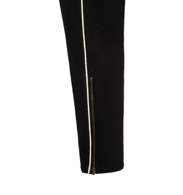 Image 4 of 4 - BLACK - HUMAN MADE Fleece Pants featuring a tapered silhouette, soft and comfortable polyester boa fleece, heart motif applique on the front, brand logo embroidered on the back pocket, line tape down the sides and side fasteners on the cuffs. 100% polyester.