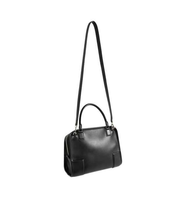 Image 3 of 4 - BLACK - LOEWE Amazona Medium 180 Bag in soft calfskin featuring a relaxed silhouette with a single toron top handle, designed to be carried open, while a concealed closure secures the main compartment, removable shoulder and crossbody straps, zip closure with two leather zip pullers, two compartments, main compartment closed with magnetic closure, internal flat pocket, suede lining and embossed logo. Soft calfskin. Made in Spain.