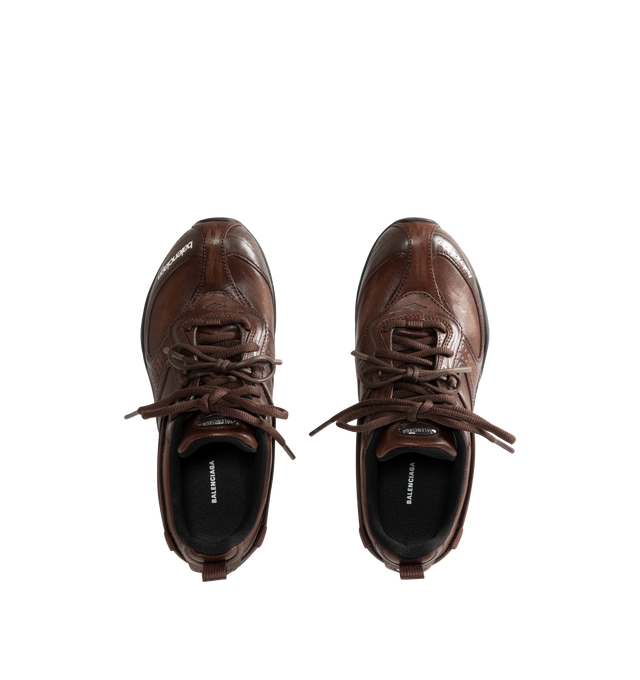 Image 5 of 5 - BROWN - Balenciaga Women's Radar Leather Sneakers are crafted from premium cowskin leather and feature a streamlined low-top silhouette with a distinctive worn-in finish, double lacing system, and debossed Balenciaga and 3B Sport logo detailing. Inspired by speed and technical performance, these designer sneakers are finished with a padded foam insole, durable rubber outsole with signature loop sports icon artwork, a back pull tab, and a sleek profile for elevated everyday wear. Upper: Cowski