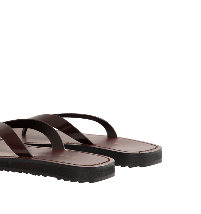Image 4 of 5 - BROWN - The Row Refined flip flop sandal in shiny calfskin leather with stitched leather detailing and lightly treaded sole. 100% Calfskin Leather. Made in Italy.