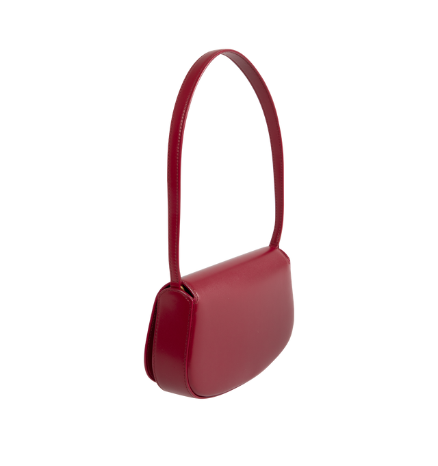 Image 2 of 3 - RED - SAINT LAURENT Mini Voltaire half-moon shoulder bag in calfskin with gently polished finish. Features a flap with magnetic Cassandre hinge closure and one flat interior pocket. Calfskin leather with leather lining and bronze-tone hardware. Made in Italy. Measures 8.3" X 4.3" X 1.8" with 9.4" strap drop.