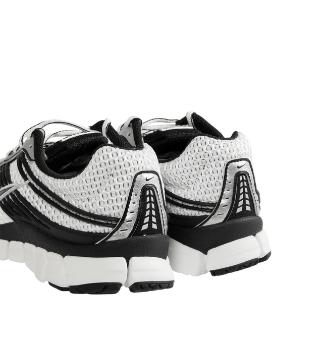 Image 3 of 5 - WHITE - Nike Men's Zoom Skylon 11 Shoes revive the late-2000s performance runner with an aerodynamic silhouette and advanced cushioning technology. Designed for comfort and everyday wear, this retro-inspired style features a chunky Air Zoom midsole with deep flex grooves and exposed cushioning pods that deliver a balanced combination of responsiveness, flexibility, and impact absorption. Materials: Textile & Synthetic upper. Midsole: Air Zoom Cushioning.