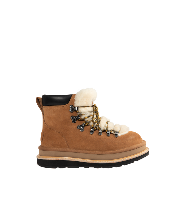 Image 1 of 4 - BROWN - UGG x sacai hiker boots designed for everyday wear, combines UGG's iconic premium  suede with sacai's unmistakable hybridized aesthetic. Upper is made with suede sourced from certified farms that practice regenerative agriculture upper. Midsole incorporates sugarcane EVA. Features Vibram XS Trek Evo. Unisex style in women's sizes.