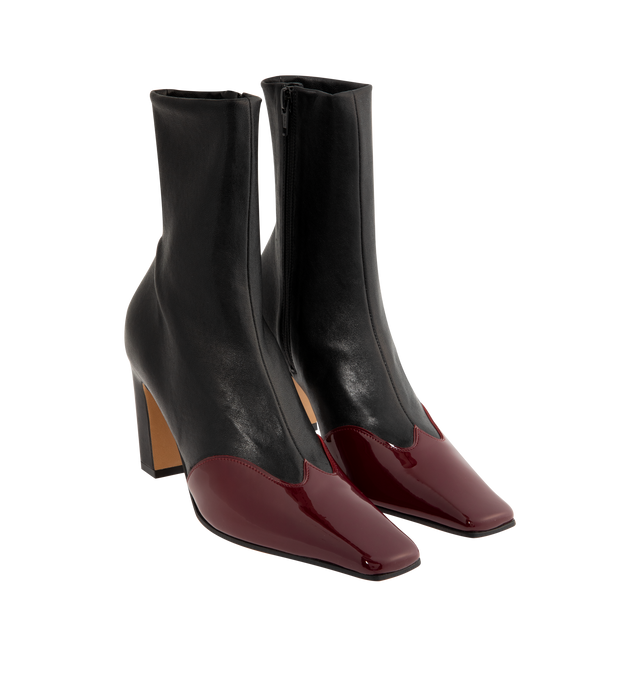 Image 2 of 4 - BLACK - KHAITE Nevada Stretch High Boot featuring a mid-calf urban cowboy boot with a squared toe, a stylized wingtip of glossy patent leather and side zipper closure. Heel Height: 3.4 in. Nappa with soft patent calf, 80% lambskin, 20% calfskin. Made in Italy.