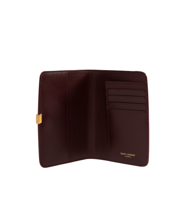 Image 3 of 3 - RED - Saint Laurent VOLTAIRE passport holder with inner card slots, decorated with the CASSANDRE. Featuring leather lining, bronze-toned hardware, two flat pockets, five card slots. Measures 5.3" x 3.9" x 0.8". Made in Italy.
