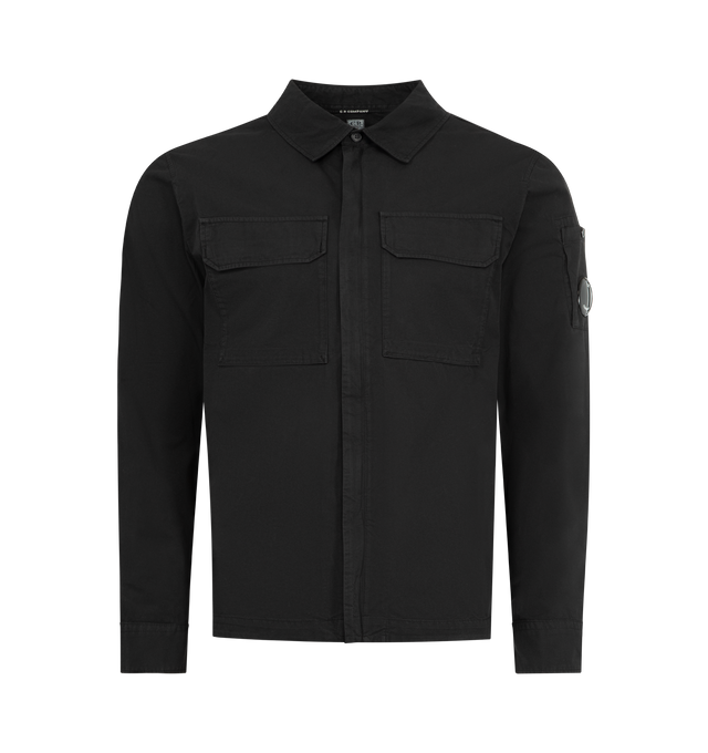 Image 1 of 3 - BLACK - C.P. COMPANY Organic Gabardine Zipped Lens Overshirt featuring classic collar, two-way concealed zip fastening, two chest flap pocket, lens detail, adjustable button cuffs and regular fit. 100% cotton. Made in Italy.