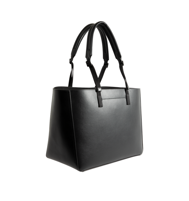 Image 2 of 3 - BLACK - Moncler Men's Carlo Leather Tote Bag is crafted from supple calf leather and features a spacious, clean-lined silhouette designed for versatile everyday use. Finished with adjustable leather handles, an interior pocket with snap-button closure, embossed and metal Moncler logo details, and a stretch polyester-blend lining, this designer tote combines refined craftsmanship with practical organization. Leather Exterior: Cow Leather. Lining: 91% Polyester, 9% Elastane/Spandex. Dimensions: