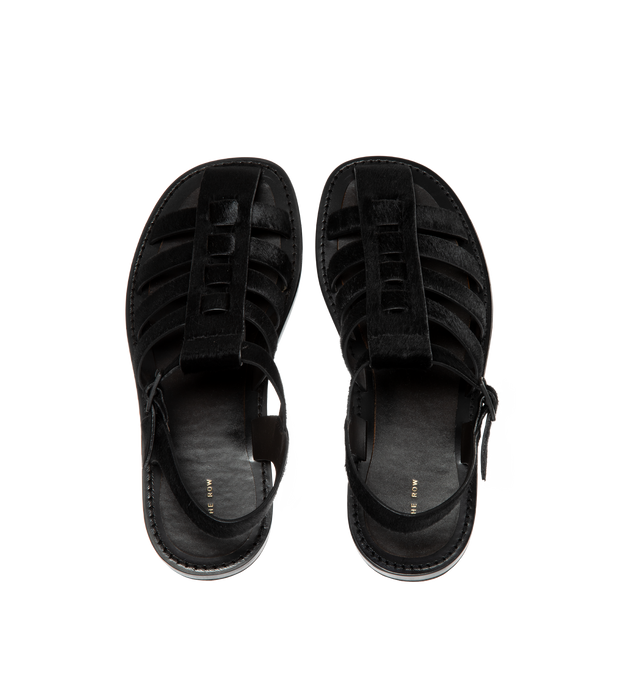 Image 4 of 4 - BLACK - THE ROW Pablo Sandal in Pony featuring artisanally-crafted fisherman sandal in smooth pony hair leather with woven leather straps, closed rounded toe, tinted buckle closure, and flexible leather sole. 100% leather. Made in Italy. 