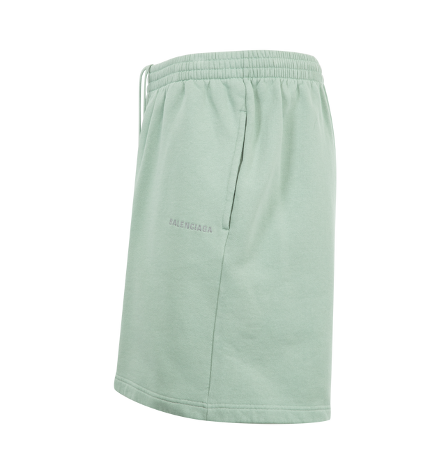 Image 3 of 3 - GREEN - BALENCIAGA Back Reflective Shorts featuring dry fleece, mid-waist, elasticated waistband, drawstring waist, 2 slash pockets at front, Balenciaga Back logo embroidered on left front leg and reflective effect artwork. 100% cotton. Made in Portugal.