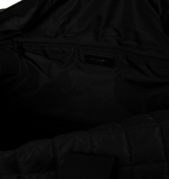 Image 3 of 3 - BLACK - SAINT LAURENT Nuxx Duffle Bag featuring quilted ECONYL, two long top handles, an adjustable and removable shoulder strap with sliding pad, debossed signature on front, two way zipper closure, one exterior pocket and one zip pocket. 19.6 X 9.4 X 9.8 inches. 95% polyamide, 5% metal. 