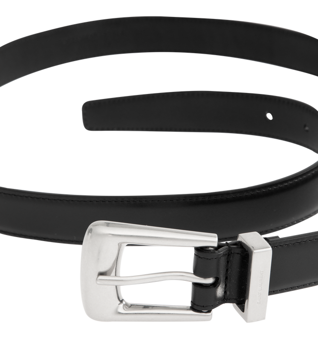 Image 2 of 2 - BLACK - SAINT LAURENT Folk Belt featuring belt in lightly polished leather with a folk buckle, SAINT LAURENT engraved metal loop, pointed end tip, and silver-tone hardware. Dimensions: 2.5 CM / 1". Calfskin. Made in Italy.