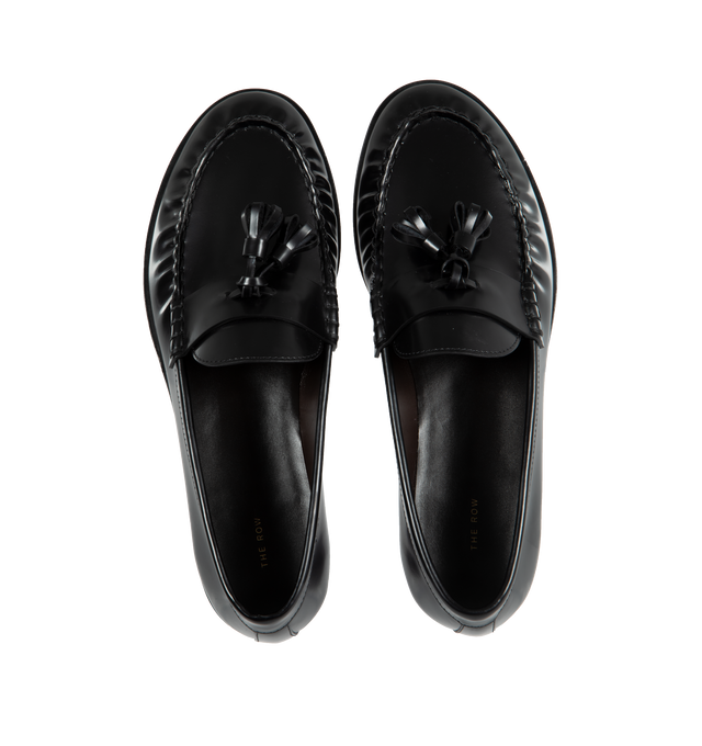 Image 4 of 4 - BLACK - THE ROW Loafer featuring sleek calfskin leather with natural pleating effect and tassel detailing. 100% leather. Made in Italy. 