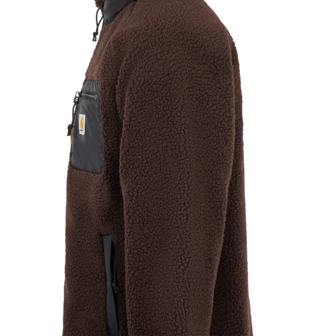 Image 3 of 3 - BROWN - Carhartt WIP Men's Prentis Liner Jacket is crafted from heavyweight polyester fleece and features a mock neck, contrast trim, embroidered logo detailing, and a front zip closure. Designed with a lined interior and zip front pockets, this relaxed silhouette combines warmth and functionality in a workwear-inspired design. Main Material: 100% Polyester. Trim: 100% Nylon. Lining: Lined. Collar: Mock Neck. Closure: Front Zip. Pockets: Front Zip Pockets. Details: Contrast Trim, Embroidered