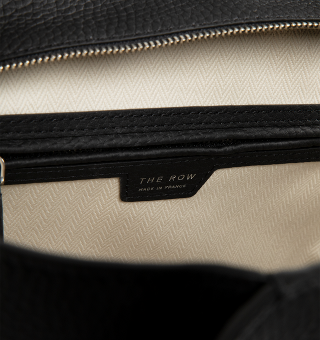 Image 3 of 3 - BLACK - THE ROW Marlo 12 Bag in Leather featuring a softly structured tote bag in polished saddle leather with tubular handles, gusseted side panels, and top zipper closure. 12 x 5 x 8.5 in. 100% calfskin leather. Lined in 100% cotton. Made in France.