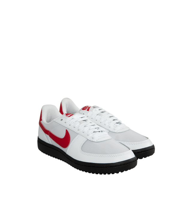 Image 2 of 5 - WHITE - NIKE Field General '82 in White and Varsity Red with a vintage gridiron look and red Swoosh.  A mix of smooth leather, synthetic leather and tough textiles come together in classic White and Varsity Red, resting atop a nubby Black rubber waffle sole.  Featuring textile Upper with leather overlays, woven tongue label, printed branding at back and rubber outsole. 