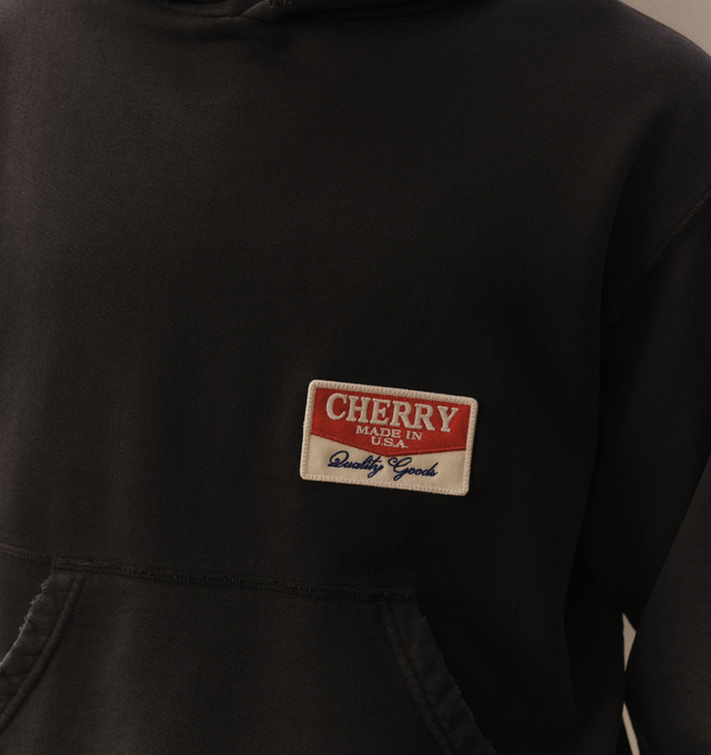 Image 6 of 6 - BLACK - Cherry LA Chevron Pullover Hoodie is crafted from custom cotton fleece and features a boxy-fit silhouette with a classic pullover design. Designed with a chest patch, distressed detailing, and a branded label at the cuff, this everyday essential combines a relaxed fit with Cherry LA's signature worn-in aesthetic. Main Material: Custom Cotton Fleece. Made in Los Angeles, California.