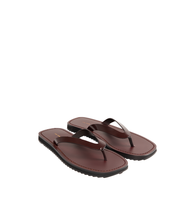 Image 3 of 5 - BROWN - The Row Refined flip flop sandal in shiny calfskin leather with stitched leather detailing and lightly treaded sole. 100% Calfskin Leather. Made in Italy.