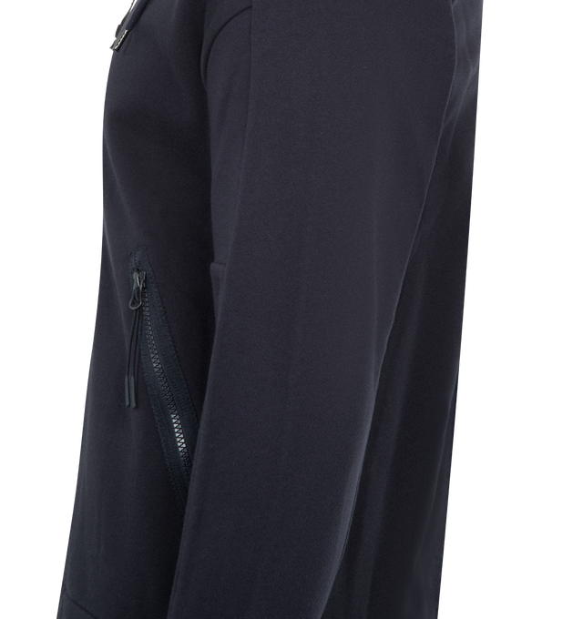 Image 4 of 4 - NAVY - C.P. COMPANY Diagonal Raised Fleece Goggle Sweatshirt featuring adjustable Goggle hood, side zip pockets, ribbed cuffs and hem, thumb hole on cuffs and regular fit. 100% cotton.