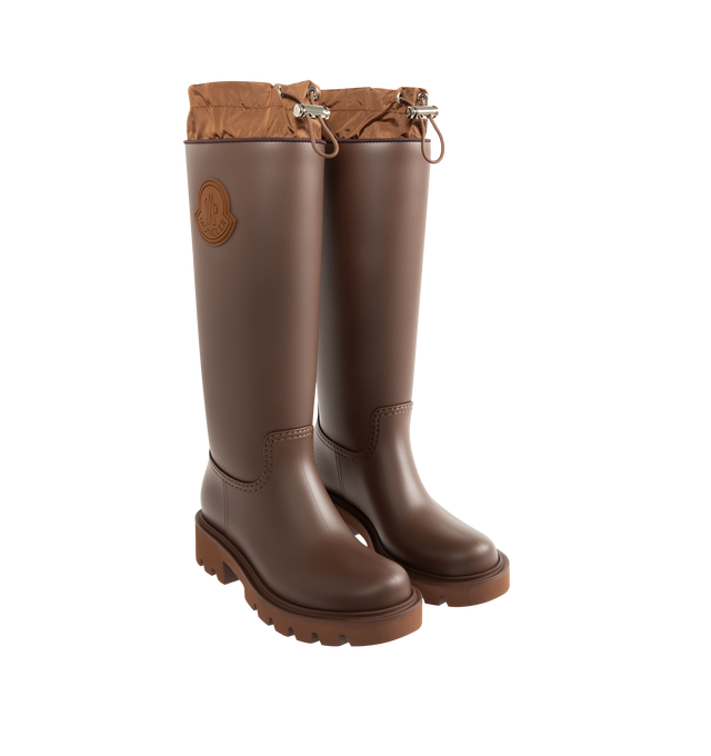 Image 2 of 4 - BROWN - MONCLER Kickstream High Rain Boots featuring PVC and nylon upper, fabric insole, TPU welt, EVA tread, drawstring fastening and waterproof. Calf height 35 cm. Sole height 4 cm. 100% polyvinyl chloride. Lining: 80% polyamide/nylon, 20% elastane/spandex. Sole: 100% elastodiene. Made in Italy.