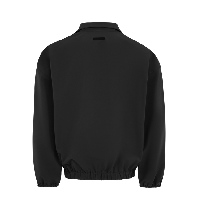Image 2 of 3 - BLACK - FEAR OF GOD ESSENTIALS Active Trace Half Zip Track Jacket featuring perforated lining for breathability, detailed with an embroidered Essentials active trace logo on the sleeves, relaxed, rounded silhouette, high neck, half-zip front, elasticized cuffs and waist hem and Essentials signature label is at the back collar. 100% polyester.