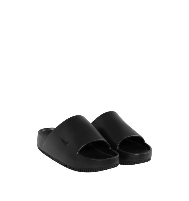 Image 3 of 5 - BLACK - NIKE Calm minimalist slides with debossed Nike Swoosh logo. Contoured foam composition is super soft with a responsive feel. The textured footed is for the stay-put foot placement. This shoe has a full-length rubber outsole for guaranteed grip on all surfaces with quick-drying design. 