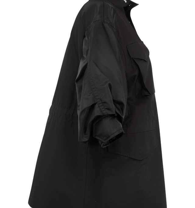Image 4 of 4 - BLACK - Sacai oversized jacket in cotton weather cloth featuring nylon twill sleeve panels, high stand collar with zipper detail, concealed front closure, flap pockets at the chest and waist, and a sleeve zip pocket. Outer fabric is 100% cotton with 100% nylon sleeves and 100% polyester lining and fill. Made in Japan.