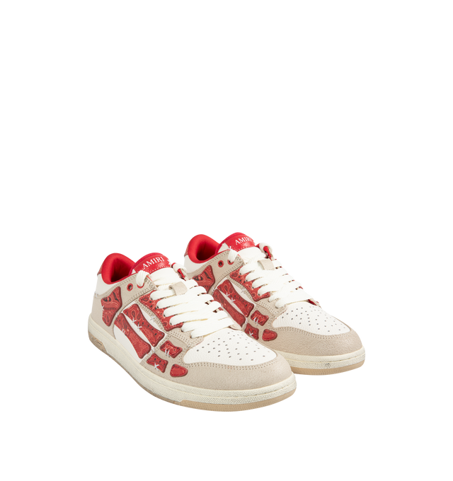Image 2 of 5 - RED - AMIRI Bandana Skel Top Low Sneakers featuring low-top, buffed leather, logo pattern embossed throughout, perforated detailing at toe, lace-up closure, logo patch at padded tongue, padded collar, bandana print appliqus at sides and treaded rubber sole. Upper: leather. Sole: rubber.