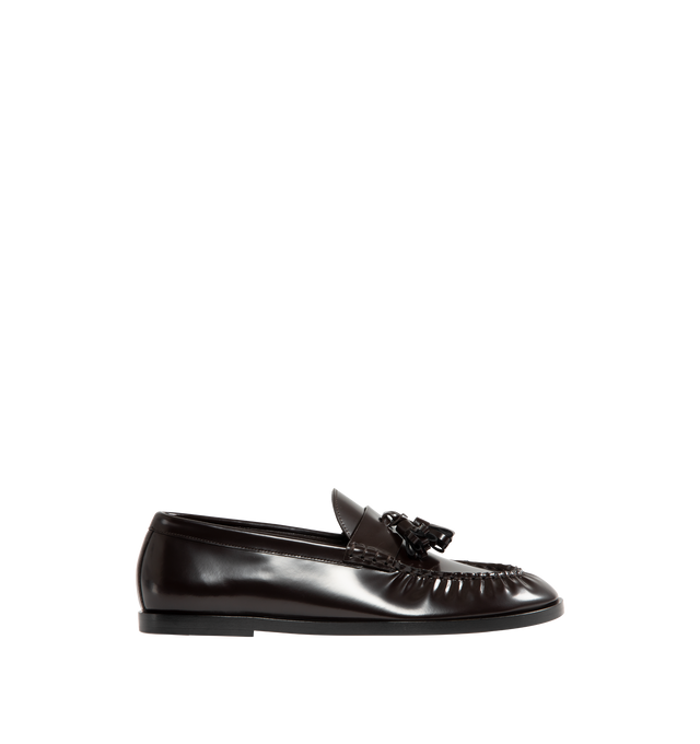 Image 1 of 4 - BROWN - THE ROW Loafer featuring sleek calfskin leather with natural pleating effect and tassel detailing. 100% leather. Made in Italy.