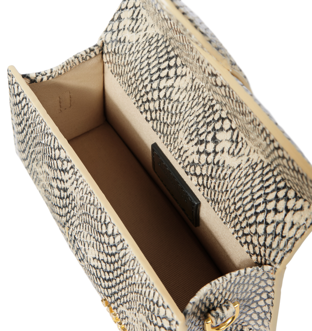 Image 4 of 4 - NEUTRAL - JACQUEMUS Bambino Bag featuring crossbody flap bag, structured, cobra-embossed leather, reinforced handle, magnetic flap, removable, adjustable shoulder strap, engraved lobster clip, card slot patch pocket on back, topstitching, gold metal logo and metalwork, fully lined and dyed edges. 13cm x 23.5cm. 100% goat leather. Lining: 100% cotton. Made in Italy.