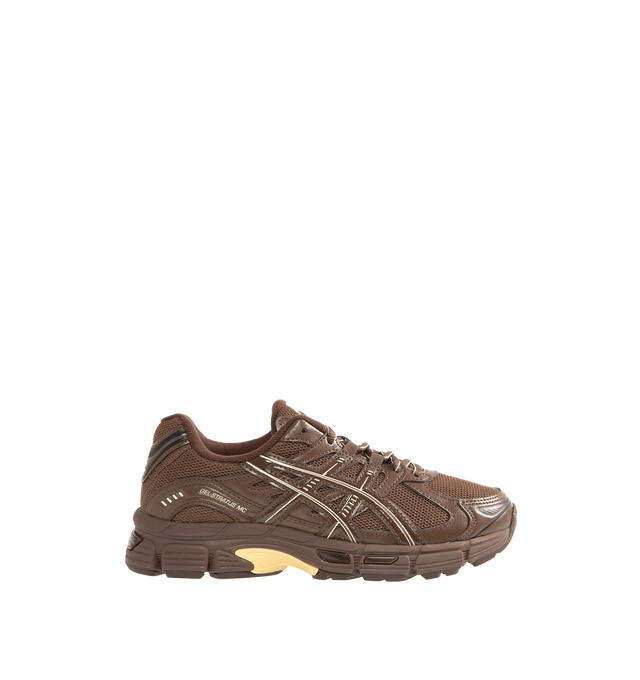 Image 1 of 5 - BROWN - Asics Unisex Emmi x Gel-Stratus MC Sneakers are crafted with synthetic leather overlays and breathable air mesh underlays and feature a streamlined silhouette inspired by technical running footwear. Designed in an exclusive Brown Storm colorway, this collaborative style is equipped with rearfoot GEL technology and GEL-JOG MC-inspired tooling for enhanced cushioning and everyday comfort. Main Material: Synthetic Leather and Mesh. Cushioning: Rearfoot GEL Technology.