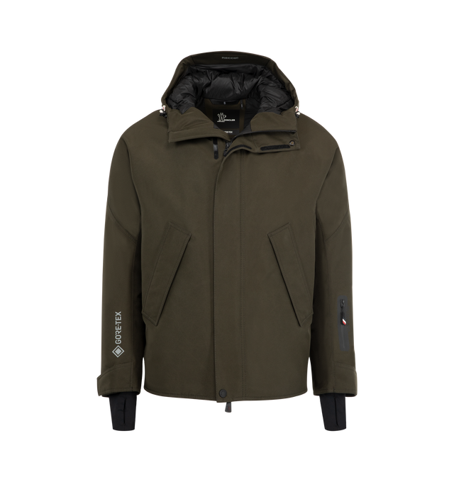 Image 1 of 3 - GREEN - MONCLER GRENOBLE Lambir Jacket featuring lightweight nylon, attached drawcord hood, long-sleeves with tab cuffs, snap button, zipper closure, zipper sleeve pocket and waist pockets. 100% polyamide. Lining: 89% polyester, 11% elastane.