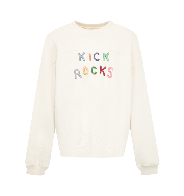 Image 1 of 2 - CREAM - Nahmias Men's Kick Rocks Varsity Long Sleeve Tee is crafted from cotton and features a loose-fit silhouette, hand-beaded detailing, and long sleeves. Designed in Los Angeles and hand-finished in India, this elevated graphic style combines artisanal embellishment with everyday comfort. Main Material: 100% Cotton. Designed in Los Angeles. Hand-Beaded in India.