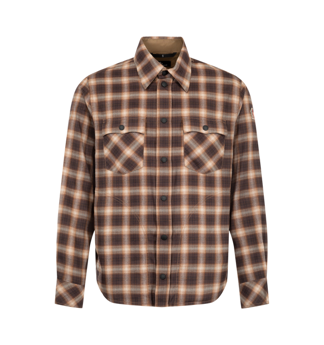 Image 1 of 1 - BROWN - Moncler Grenoble Men's Check Utility Shirt is crafted from a brushed cotton and lyocell blend and features a relaxed mountain-inspired silhouette, a classic collar, long sleeves, and a snap-button front closure. Designed with cargo-style utility pockets featuring snap-button closures, adjustable cuffs, and technical rainwear trim at the inside collar, cuffs, and pockets, this versatile layer balances comfort with functional detailing. Main Material: 57% Cotton, 43% Lyocell. Trim: 100%