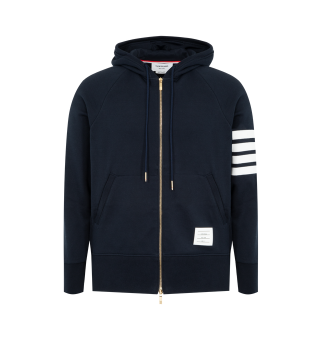 Image 1 of 2 - NAVY - THOM BROWNE Classic Loopback 4-Bar Full Zip Hoodie featuring iconic 4-Bar detailing, brass 2-way zip closure, integrated hood with stripe trim and kangaroo front pocket with name tag applique. 100% cotton. Made in Japan.