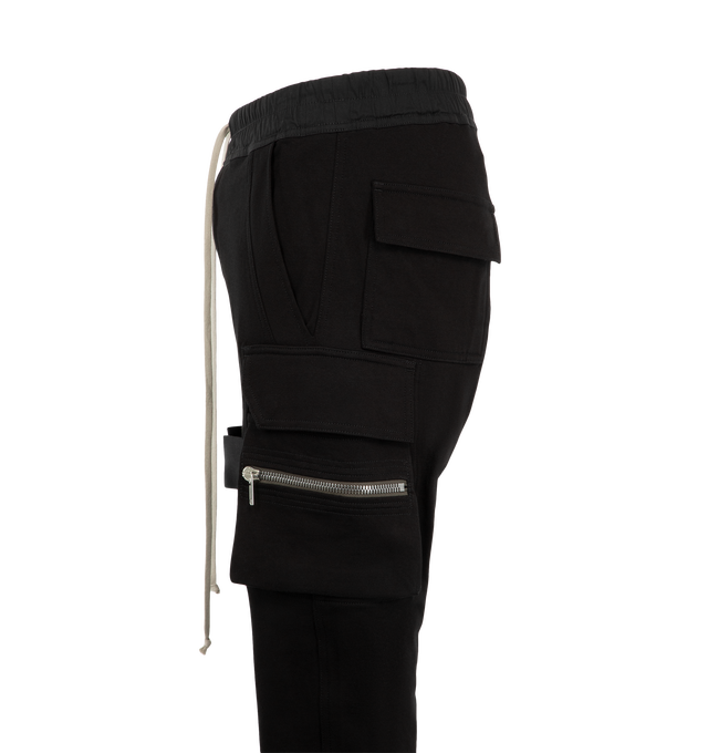 Image 3 of 3 - BLACK - Rick Owens Mens Mastodon Cargo Pants are crafted from cotton poplin. Feature a slim fit, elasticized waistband with drawstring, side pockets, zip cargo pannier pockets with flaps and tabs, back flap pockets, and elasticized ankles. Main Material: 97% Cotton, 3% Elastane. Made in Italy.