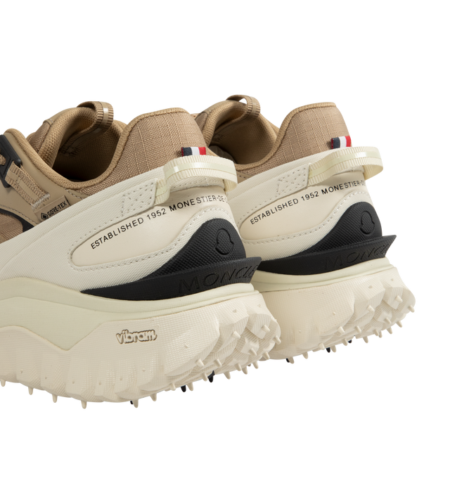 Image 3 of 5 - WHITE - Moncler Trailgrip GTX Low Top Sneakers are a lace-up style with a mix of technical materials, GORE-TEX waterproof membranes, EVA midsoles, Vibram treads, and OrthoLite insoles. Made in Vietnam.