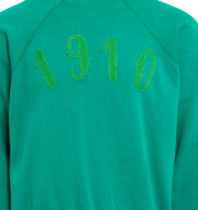 Image 3 of 4 - GREEN - This vibrant emerald green upcycled vintage sweatshirt features raglan sleeves, "1910" applique at the front, Transnomadica label at the back.  50% cotton / 50% polyester. Measurements: 26 inches in length from neckline to front hem, 26 inches from armpit-to-armpit. This collection of vintage sweatshirts, exclusively for 1910 at Hirshleifers, each featuring a hand-crafted 1910 applique at the front and Transnomadica tag at the back. Each piece features unique fit, color and design d 