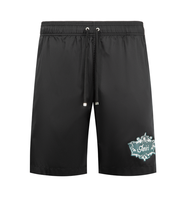 Image 1 of 3 - BLACK - AMIRI Chateau Crest Swim Trunks featuring a Chateau Crest logo on the left leg, back flap pocket, elasticized drawstring waist, side-seam and back flap pockets and pulls on. 100% polyester. Made in Portugal.