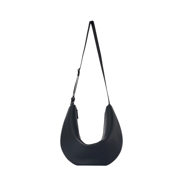 Image 1 of 3 - BLACK - THE ROW Crossbody Crescent Bag featuring crescent-shaped crossbody bag in textured calfskin leather with single seam construction, adjustable woven shoulder strap and zipper closure. 100% calfskin leather. Lined in 100% lambskin leather. Made in Italy.