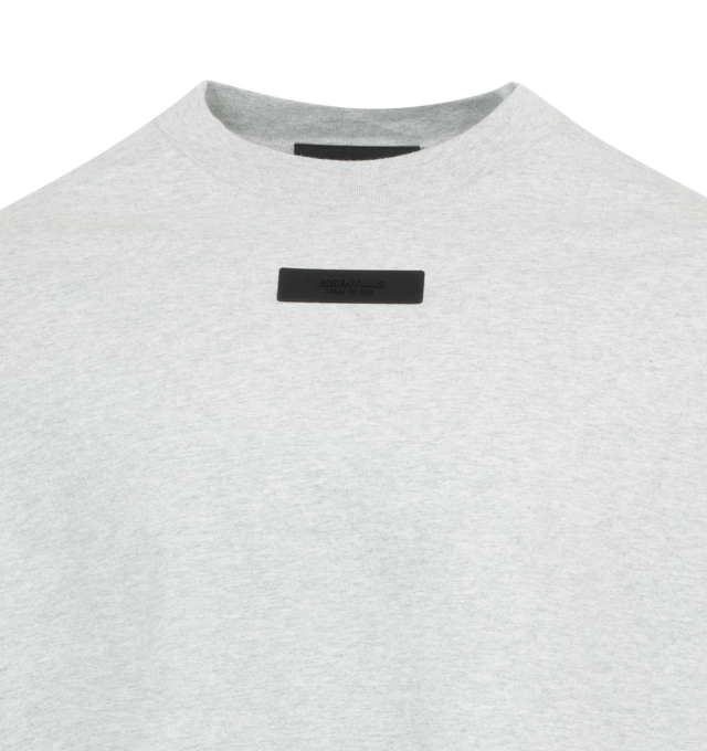 Image 2 of 2 - GREY - FEAR OF GOD ESSENTIALS Crewneck Long Sleeve T-Shirt featuring rib knit crewneck and cuffs, rubberized logo patch at chest and back and dropped shoulders. 100% cotton. Made in Viet Nam. 