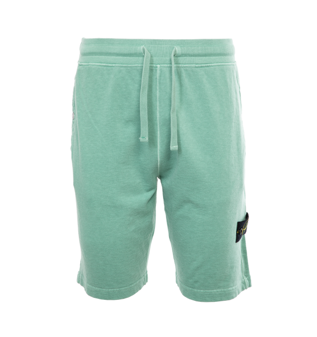 Image 1 of 4 - GREEN - STONE ISLAND Sweatshorts featuring regular fit, valet stand pockets with snap fastening, one patch pocket on back, Stone Island badge on the left leg and ribbed waistband with drawstring. 100% cotton. 