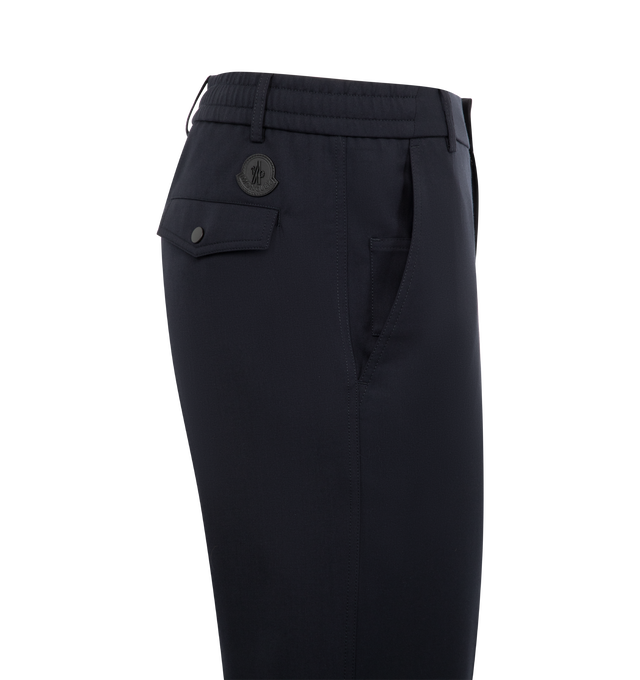 Image 3 of 3 - NAVY - MONCLER Wool Gabardine Tailored Pants featuring wool blend gabardine, zipper and button closure, pockets with snap button closure and leather logo patch. 54% virgin wool, 45% polyester, 1% elastane/spandex. Made in Romania.