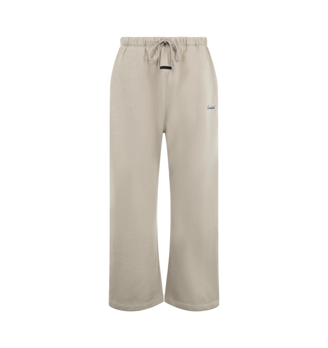 Image 1 of 3 - NEUTRAL - Fear of God ESSENTIALS Men's Signature Flare Sweatpant is crafted from heavyweight 380 GSM cotton-blend fleece and features a relaxed-fit silhouette that extends into a flared leg. Designed with the Essentials signature logo embroidered at the leg, this elevated loungewear style is finished with an encased elastic waistband, elongated drawcords, side-seam pockets, and a signature Essentials label at the center front. Main Material: 80% Cotton, 20% Polyester, 380 GSM.