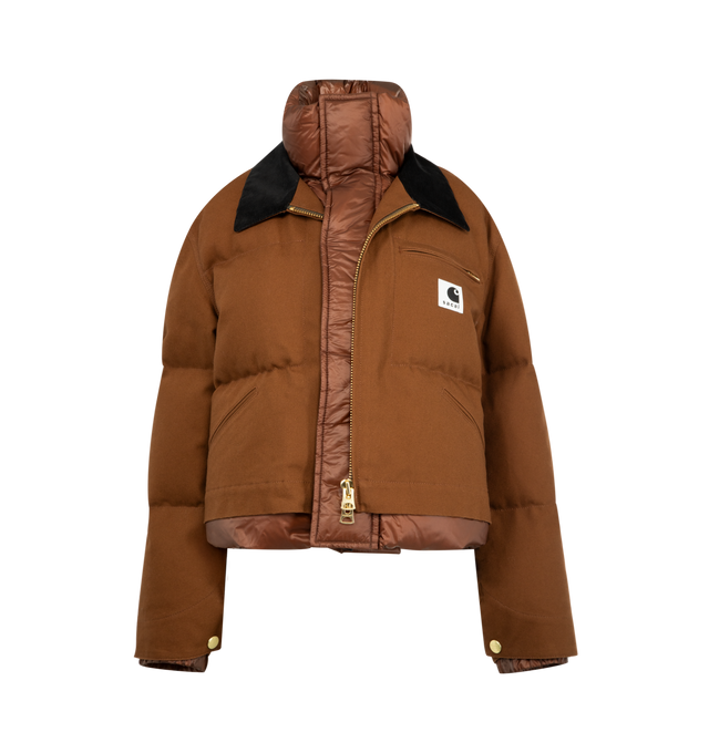 Image 1 of 3 - BROWN - Sacai x Carhartt WIP Duck Puffer Jacket in a boxy, cropped fit and layered silhouette combining a signature canvas exterior with a plush quilted nylon interior. Features stand collar and spread collar, long sleeves, elasticized snap cuffs, chest zip pocket, side patch pockets, concealed snap, two-way front zip closure, finished with a co-branded woven label. Cotton outer, 100% nylon and 100% cupro lining, 90% duck down/10% duck feather fill. Made in Japan.