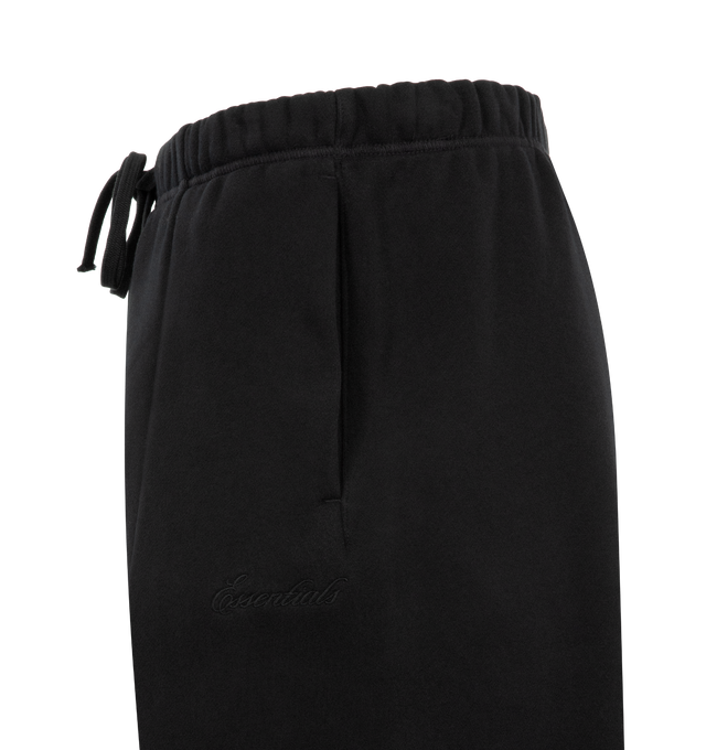 Image 3 of 3 - BLACK - FEAR OF GOD ESSENTIALS Signature Lounge Sweatpant featuring heavy 480GSM core fleece, oversized silhouette, Essentials signature logo embroidered on the leg, front leg seam, encased elastic waistband with elongated drawcords, side-seam pockets and an Essentials signature label at the center front. 80% cotton, 20% polyester.