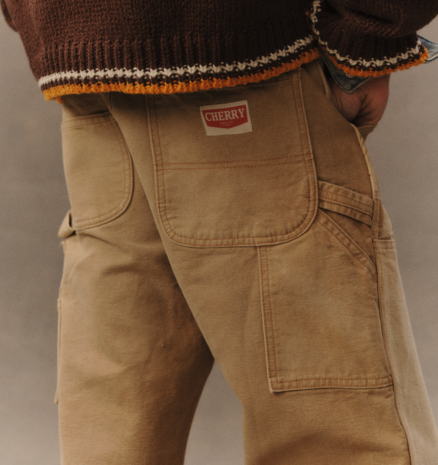 Image 7 of 8 - NEUTRAL - Cherry LA Wide Leg Double Knee Pants are crafted from durable cotton canvas and feature a wide-leg silhouette with reinforced double-knee construction. Designed with a vintage-washed finish and distressed detailing throughout, this workwear-inspired style is finished with branded nickel hardware and a signature logo label at the back pocket. Main Material: Cotton Canvas. Fit: Wide Leg. Made in Los Angeles, California.