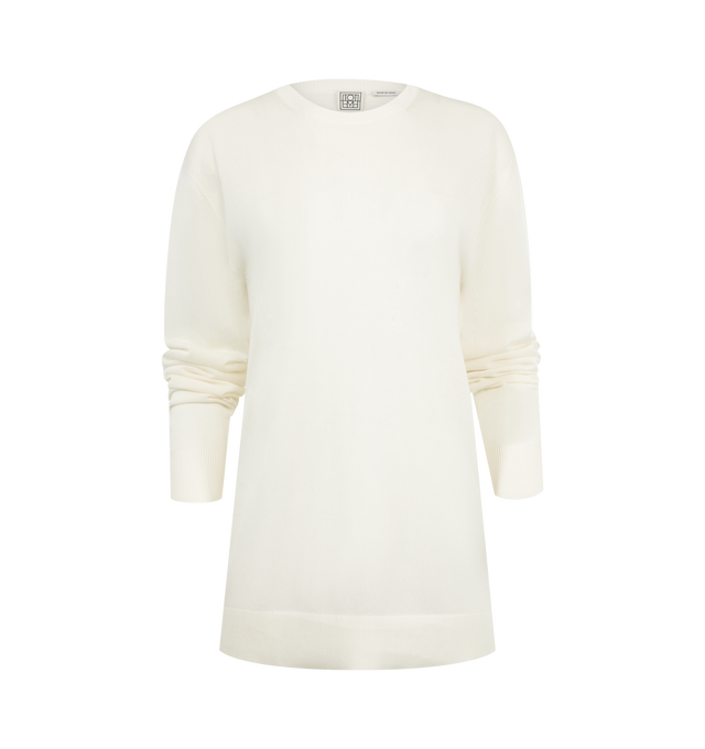 Image 1 of 2 - WHITE - TOTEME Long-Sleeve Knit Tee featuring oversized fit, crew-neck, long sleeves and light, semi-sheer knit. 90% lyocell, 10% cashmere.