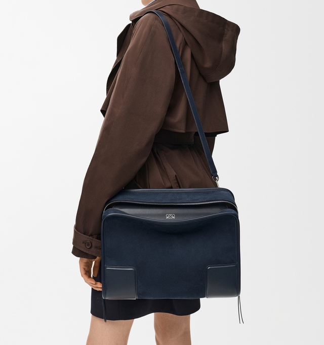 Image 4 of 16 - NAVY - Loewe Large Amazona 180 Bag in suede featuring a relaxed silhouette anchored by a single toron top handle, designed to be carried open while a concealed closure secures the main compartment, removable shoulder and crossbody straps, zip closure with two leather zip pullers, two compartments, main compartment closed with magnetic closure, internal flat pocket, left side d-ring for customization, suede and nappa lambskin lining, embossed LOEWE and embossed double L branding. Suede/calf.  
