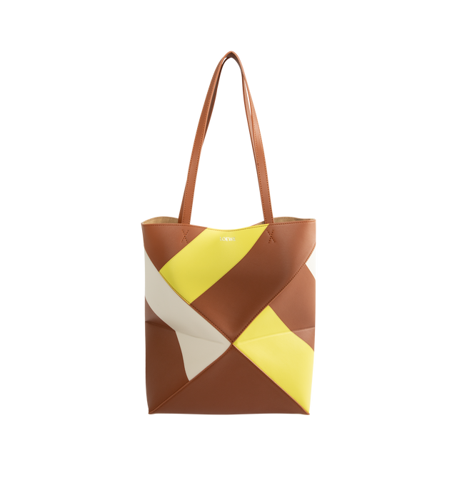 Image 1 of 3 - MULTI - Loewe Medium-Sized Puzzle Fold Graphic Tote Bag is crafted from calfskin leather and features the brand's signature geometric Puzzle Fold construction with a lightweight, foldable design. Designed with double top handles, a front logo detail, and multicolor graphic motifs created using Loewe's signature intarsia technique for a distinctive sculptural appearance. Main Material: Calfskin Leather. 